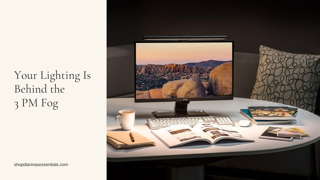 BenQ ScreenBar light bar clipped to the top of a monitor, lighting a home desk with a notebook, coffee, and magazines
