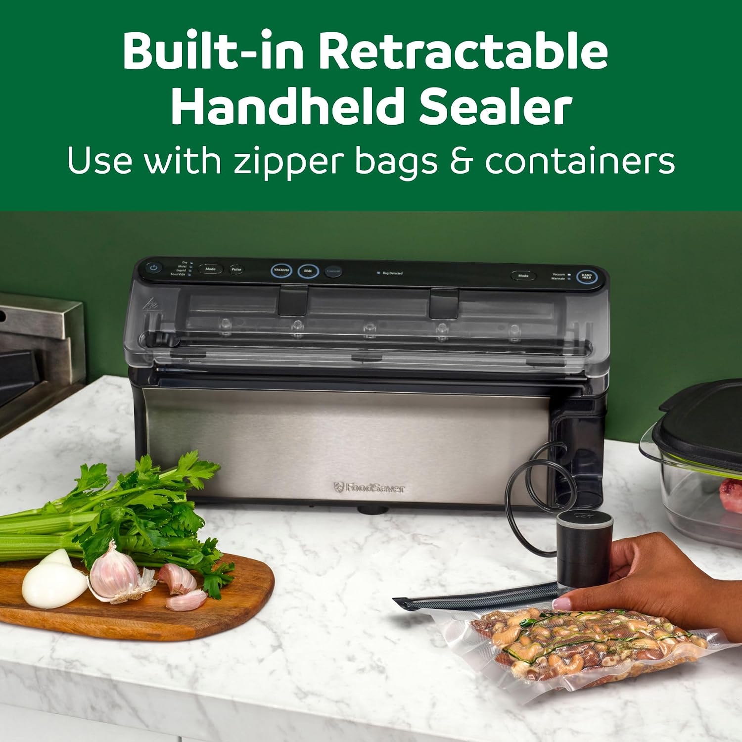 FoodSaver Elite on a kitchen counter with vegetables beside it, a hand using the retractable handheld sealer on a bag of food