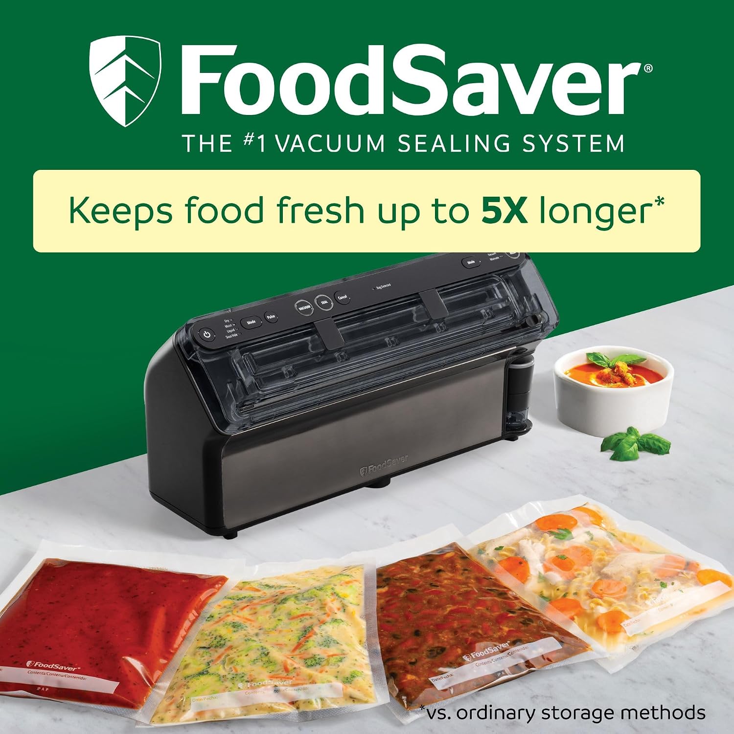 FoodSaver Elite vacuum sealer on a countertop with four sealed food bags, text reads Keeps food fresh up to 5 times longer