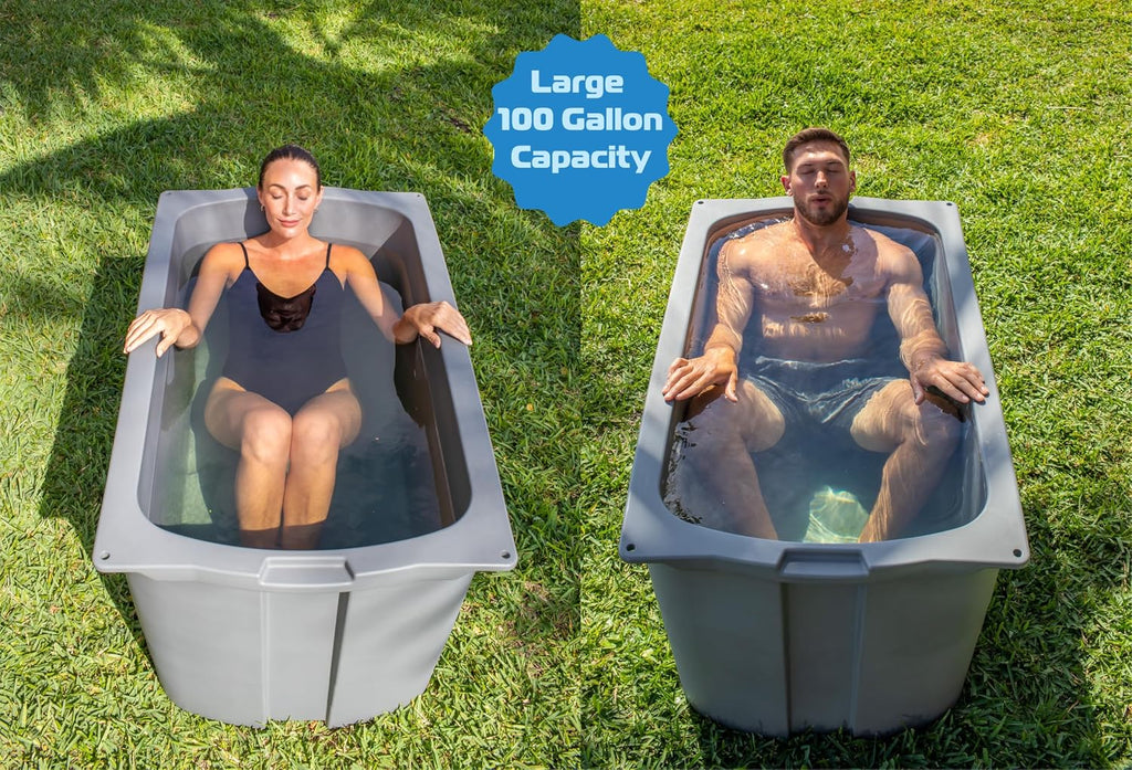 Two people submerged in separate Frozin 400 cold plunge tubs on a lawn, showing the large 100-gallon capacity fits different body types