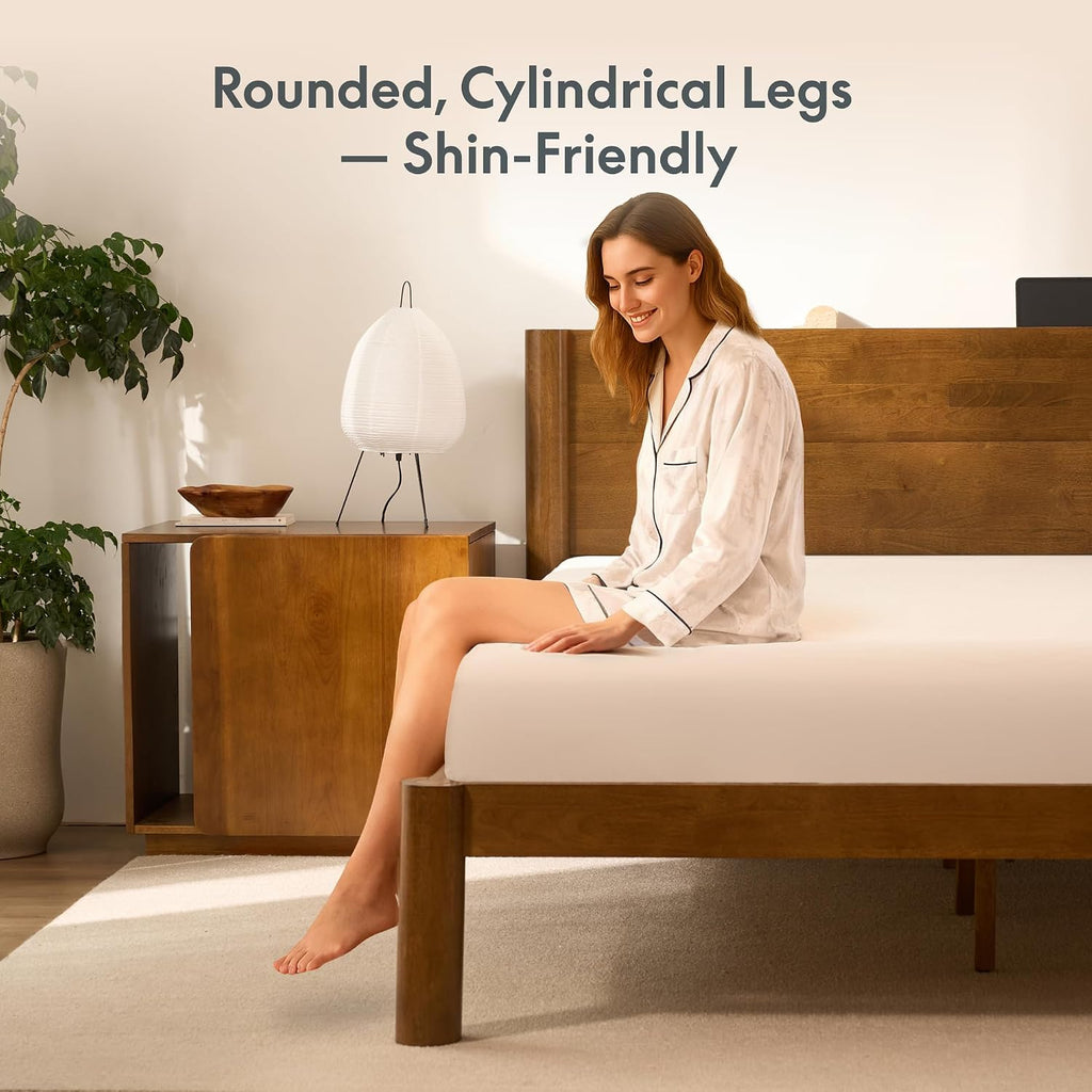 Woman sitting on the FLEXISPOT Hako G2 bed frame, text reads Rounded, Cylindrical Legs, Shin-Friendly