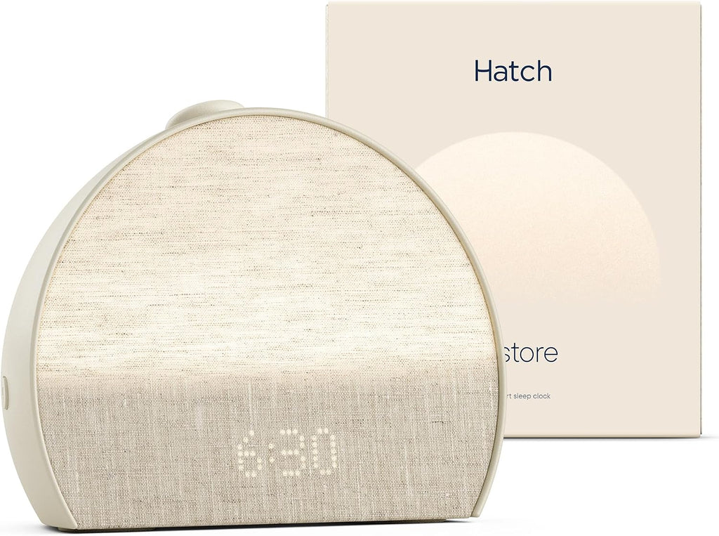 Hatch Restore 3 sunrise alarm clock in putty finish displaying 6:30, shown with its retail box