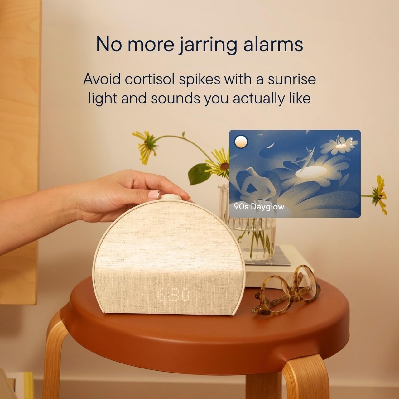 Hatch Restore 3 on a wooden stool showing 6:30, promoting a gentle sunrise wake-up without jarring alarms