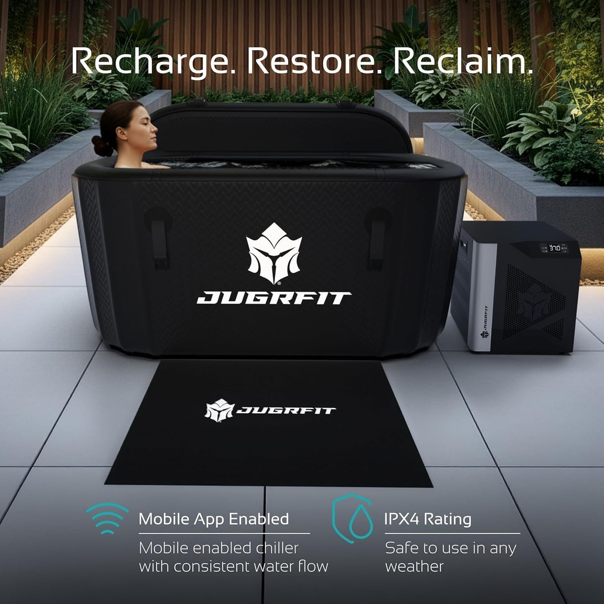 Woman relaxing in a black JUGRFIT inflatable cold plunge tub with chiller and floor mat on a landscaped patio
