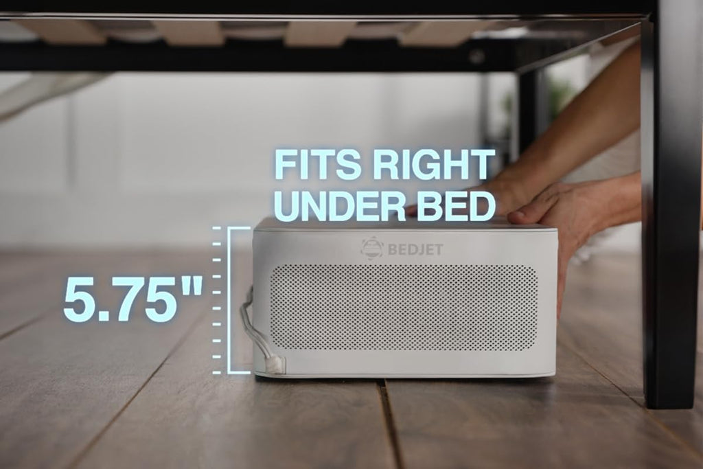 Hand placing the BedJet unit under a bed frame, text reads Fits Right Under Bed, 5.75 inches tall