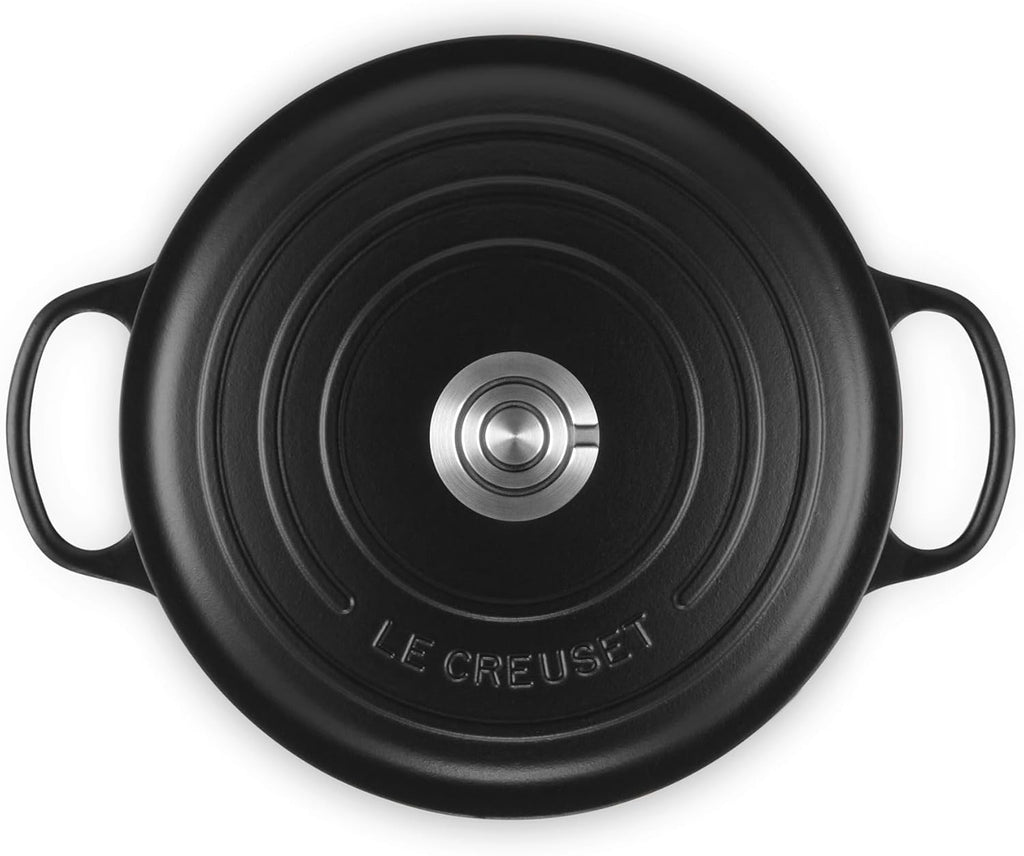 Le Creuset Signature Round Dutch Oven in black, three-quarter view showing the knob lid