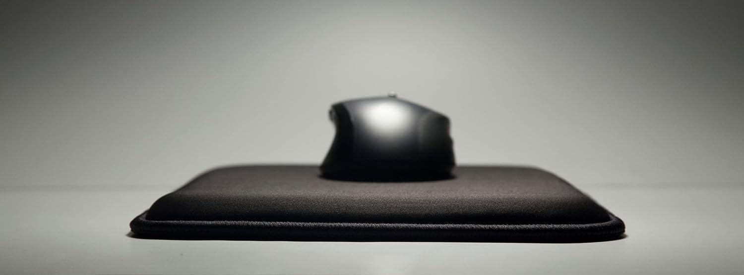 Close-up side profile of the black Loftmat cushioned mouse pad with a mouse resting on top