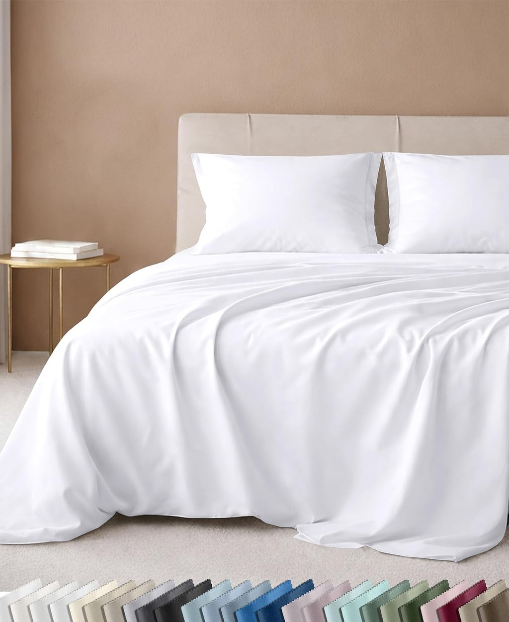 California Design Den sheet set in white on a bed with an upholstered headboard, with a color swatch strip below showing the full palette