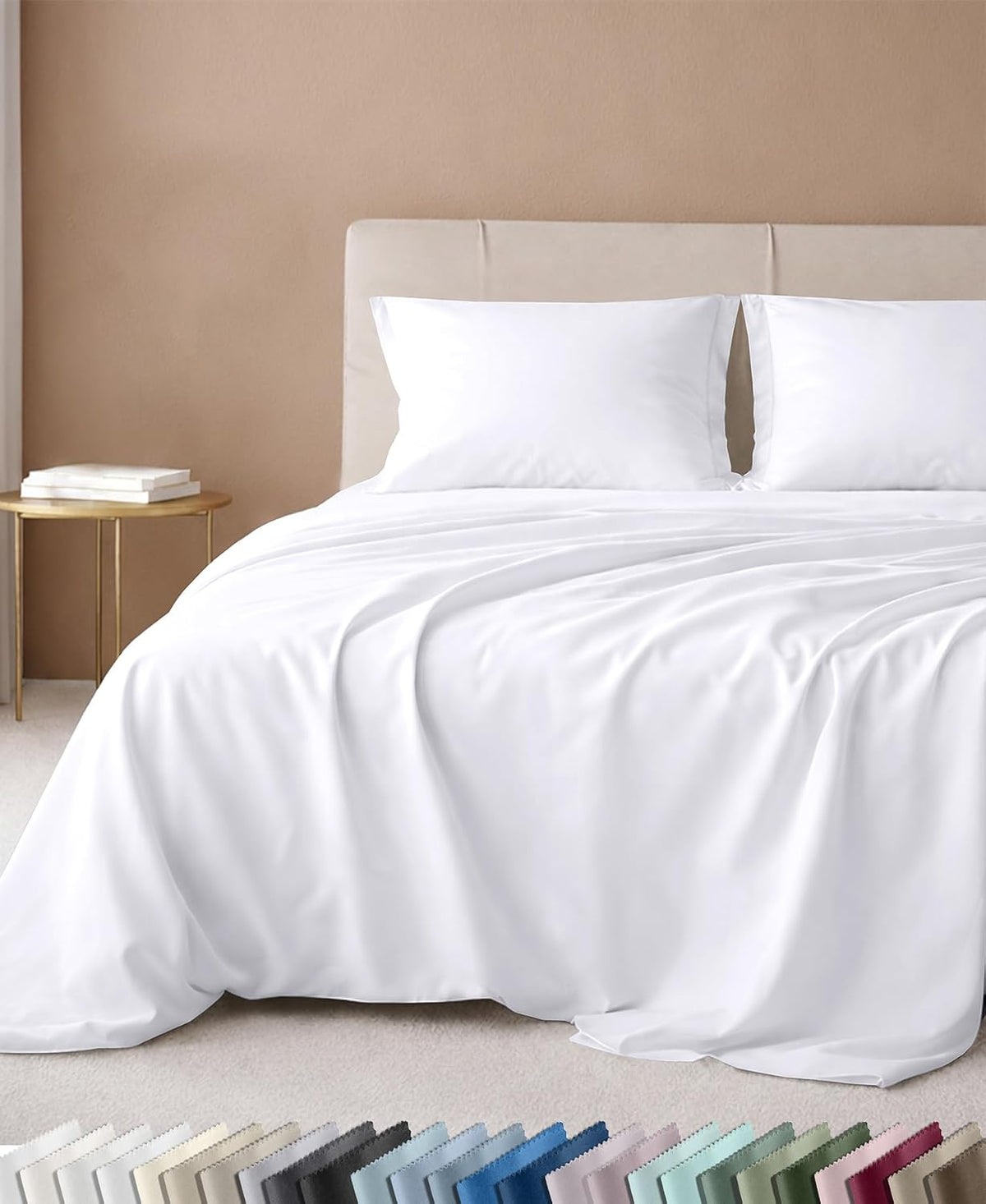California Design Den sheet set in white on a bed with an upholstered headboard, with a color swatch strip below showing the full palette