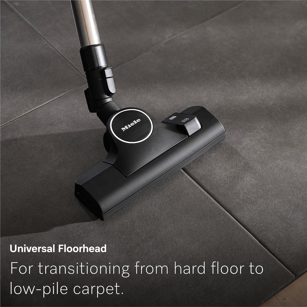Miele Guard L1's Universal Floorhead transitioning from hard floor to low-pile carpet
