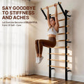 Woman doing a hanging knee raise on a GMWD wooden Swedish ladder stall bar mounted on a home wall by a window