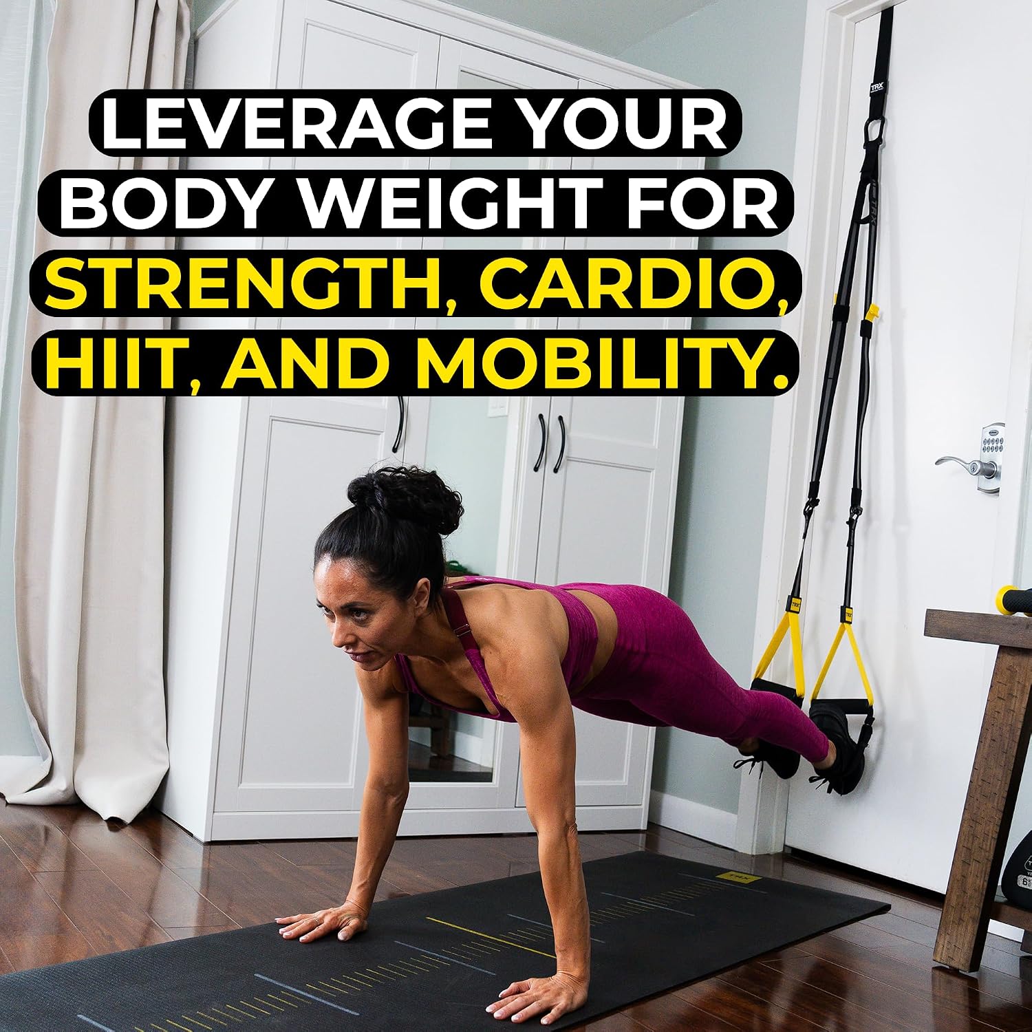 Woman doing a TRX plank exercise at home, text reads Leverage your body weight for strength, cardio, HIIT, and mobility