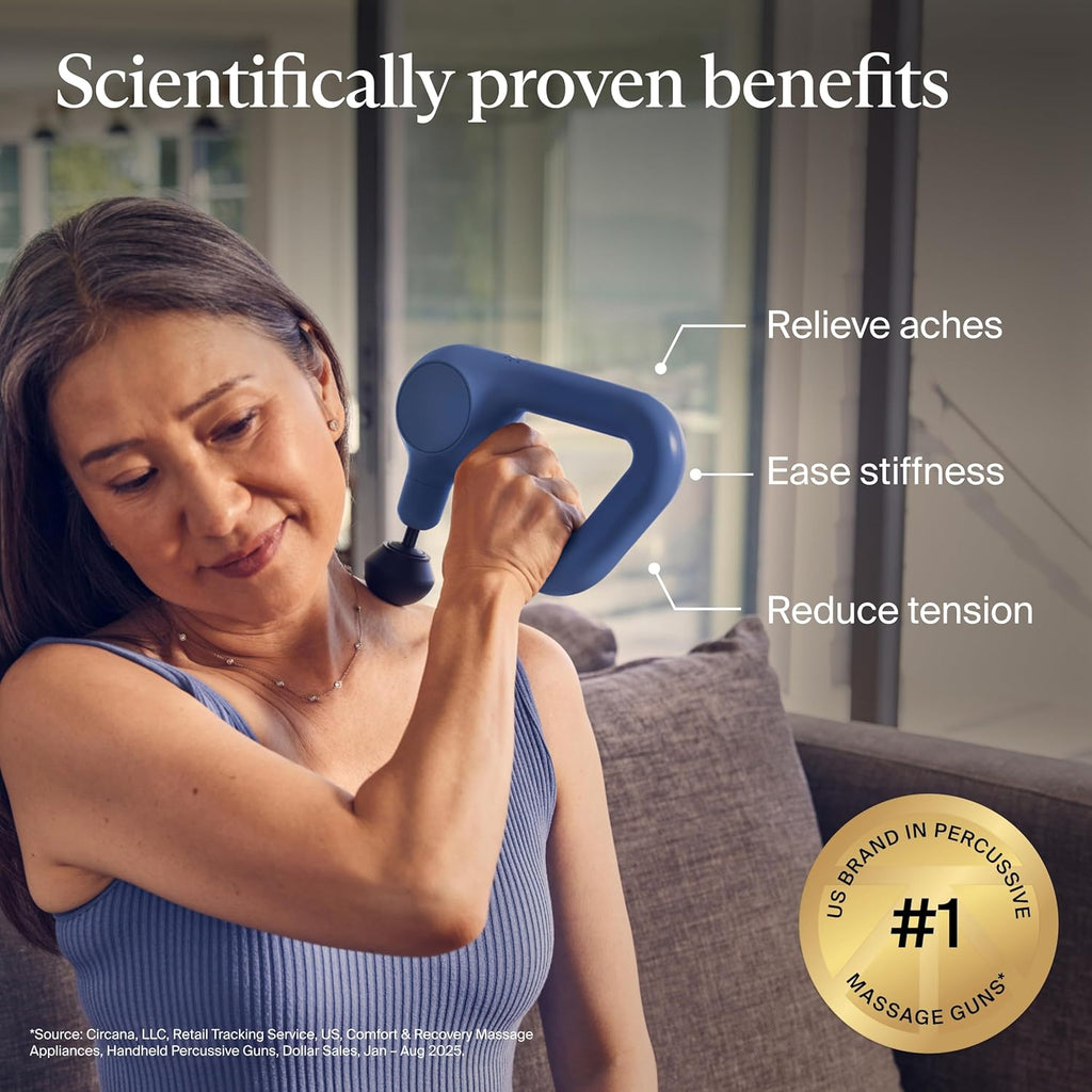 Woman using the TheraGun Relief massage gun on her shoulder to relieve aches and ease stiffness