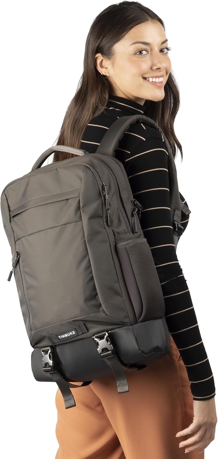 Woman wearing the Timbuk2 Authority Laptop Backpack Deluxe in gray on one shoulder