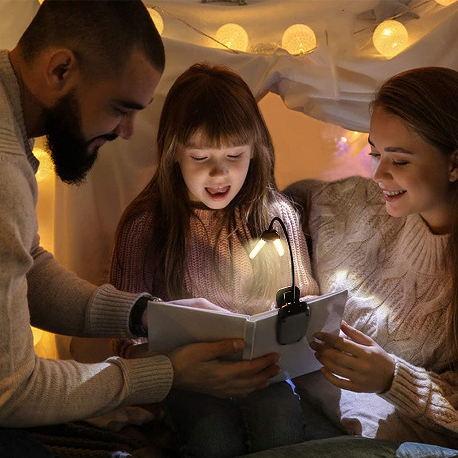 Child reading in bed at night using the Vekkia clip-on book light