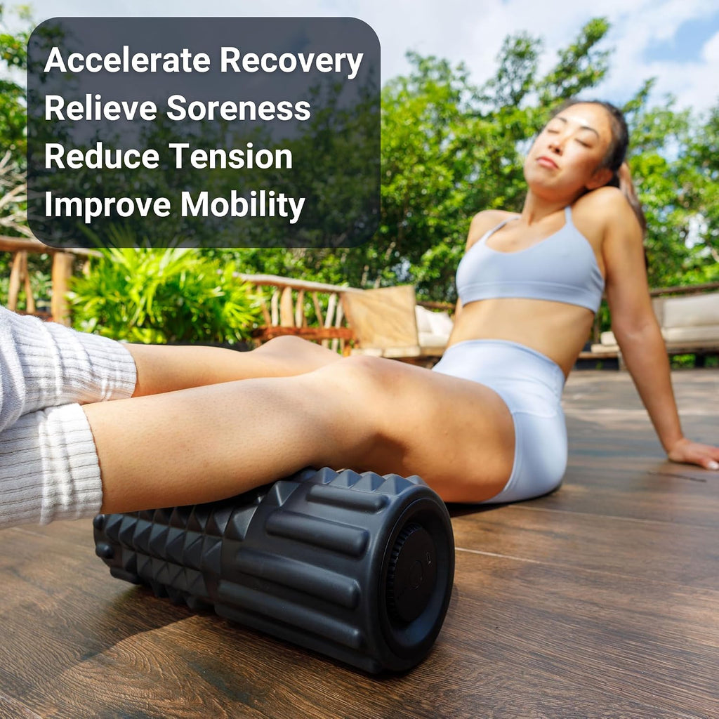 Woman using the VibePro Flow vibrating foam roller on her leg outdoors to relieve soreness