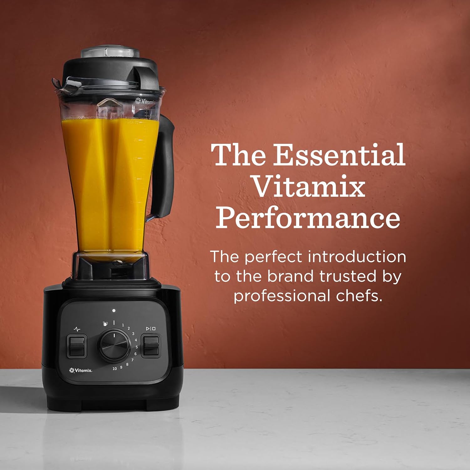 Vitamix VX1 blender filled with orange juice, labeled The Essential Vitamix Performance
