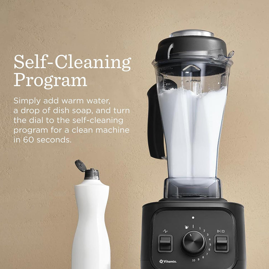 Vitamix VX1 blender running its self-cleaning program with warm water and dish soap