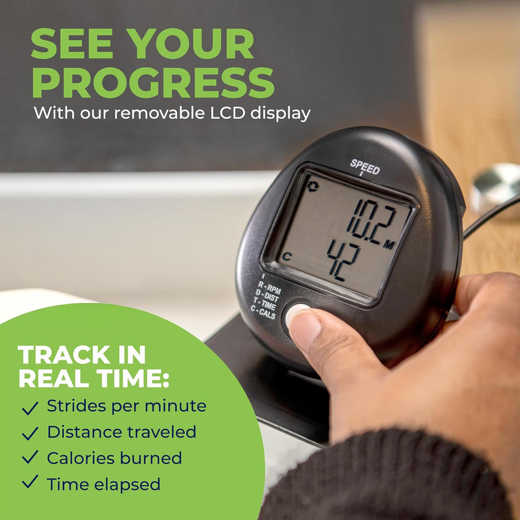 Close-up of a hand holding the DeskCycle 2 removable LCD display showing distance and calories, text reads See your progress