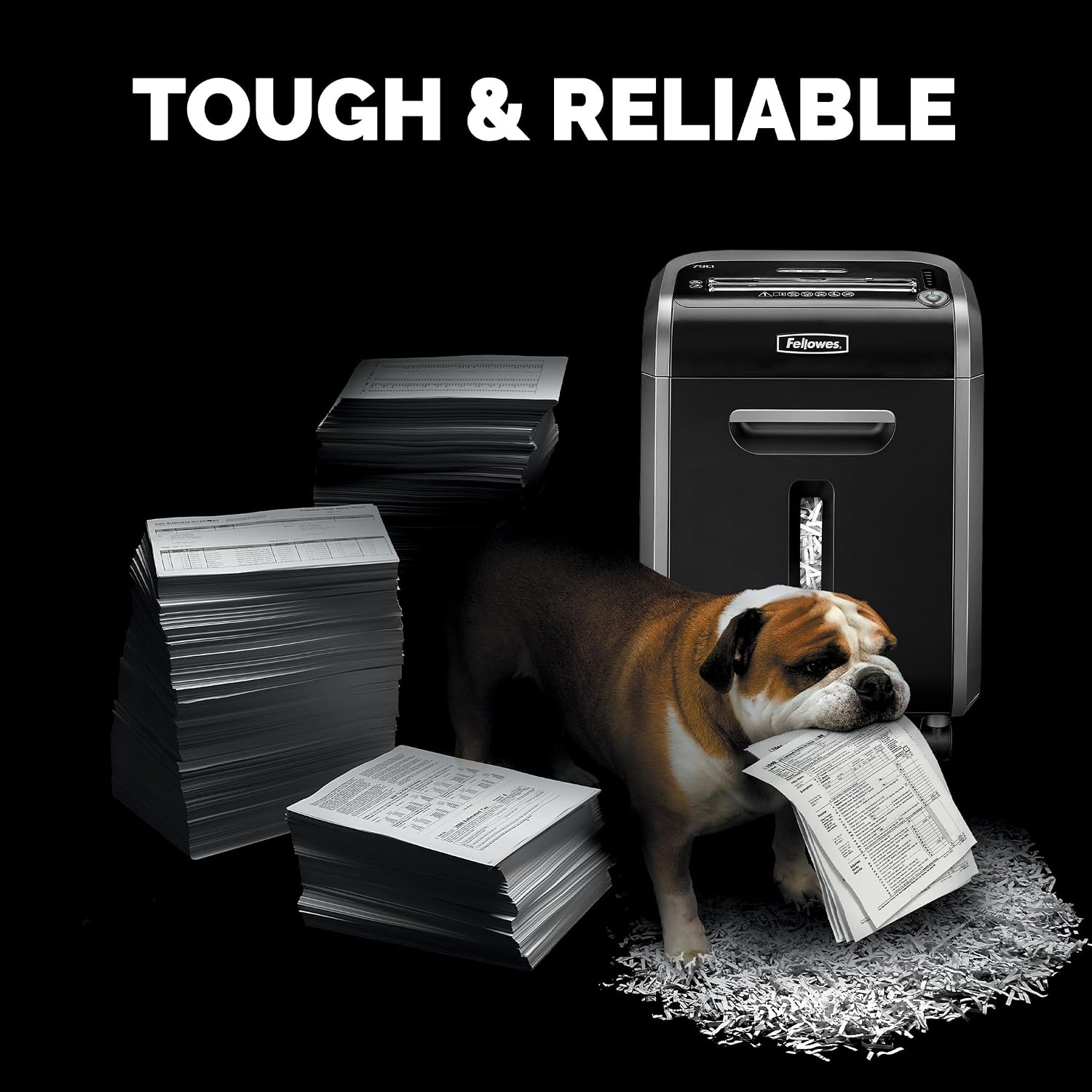 Bulldog resting against the Fellowes Powershred 79Ci next to stacked paper, illustrating tough and reliable shredding capacity